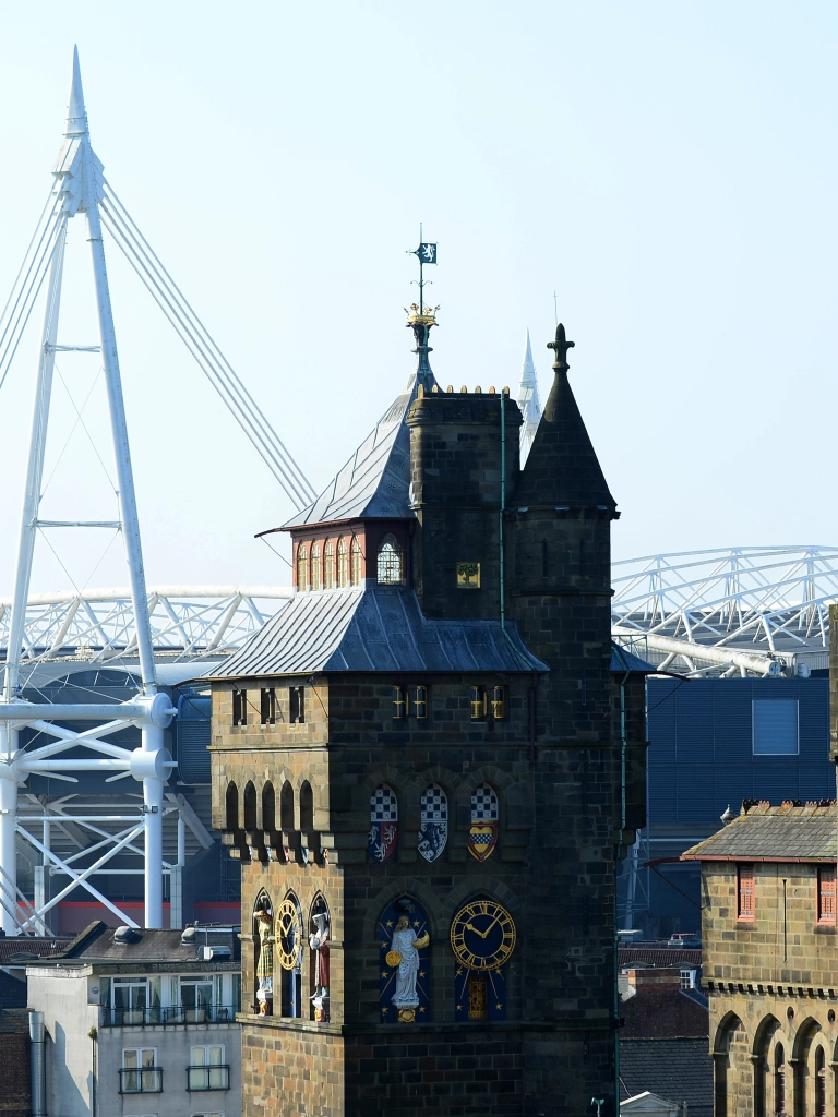 Views of a castle and sports and entertainment arena in a city centre.