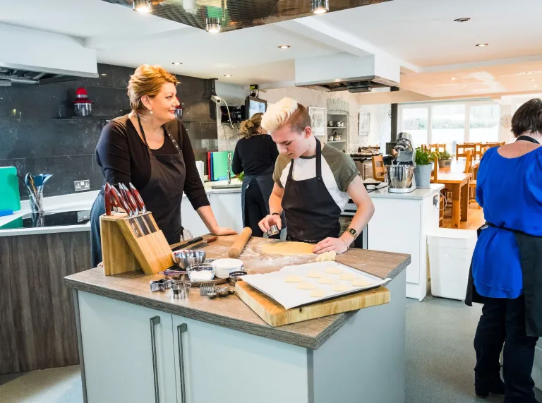 Angela Gray overseeing her customers preparing food at her cookery school.