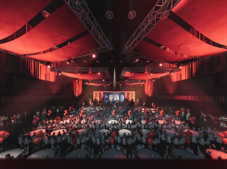 Interior of Swansea Arena set up for a banquet wth red ceiling drapes and tables laid out 