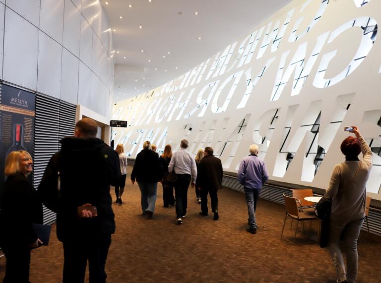 people walking around the WMC looking a the  inscription wall 