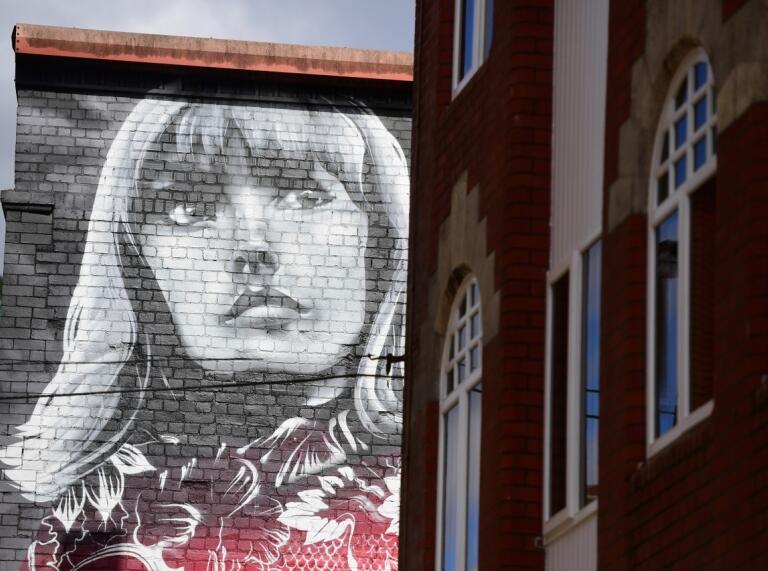 image of a woman drawn onto the side of a building in Womanby Street Cardiff 