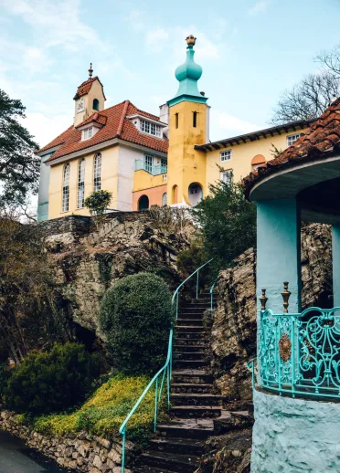 Steps leading up to colourful buildings on a rocky hill.