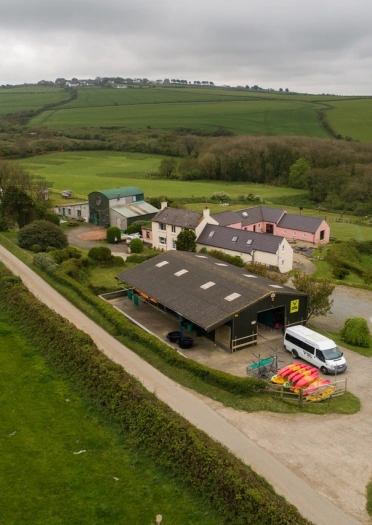 An aerial shot of Preseli Venture with canoes and mini bus in view.