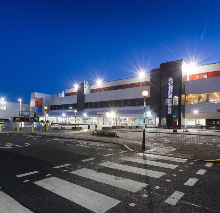 External shot of Cardiff Airport brightly lit at night.