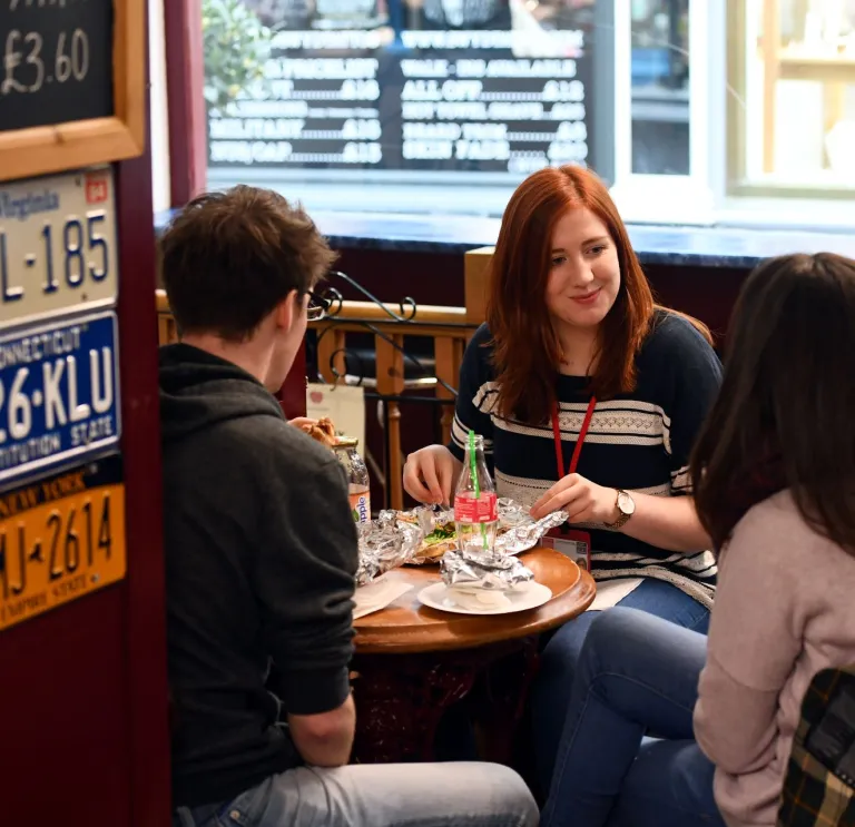 People sitting around a table eating a meal.