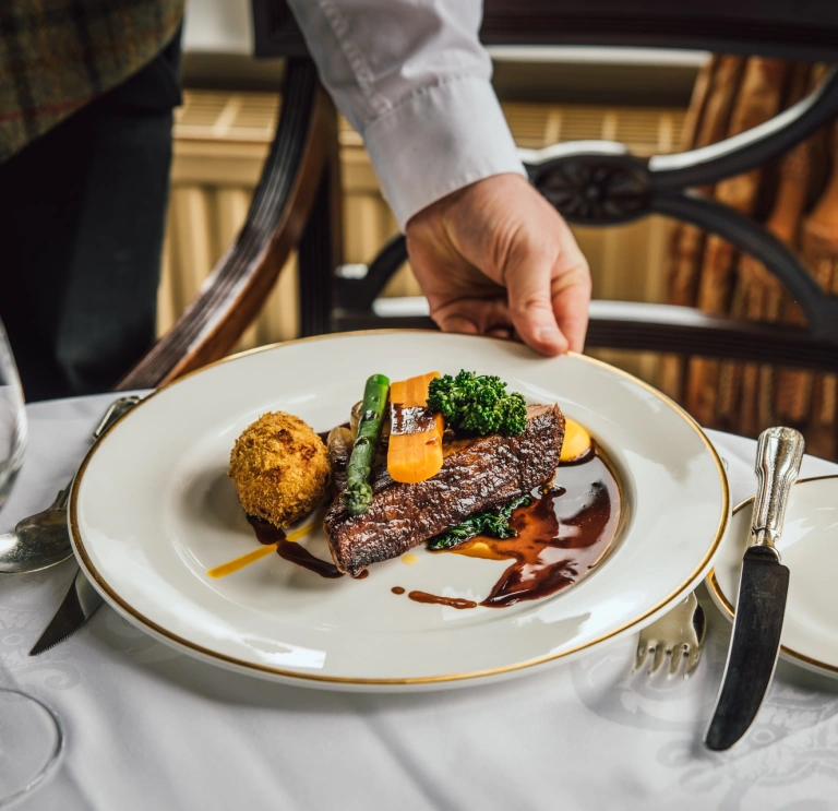 A plate of food being served on a table.