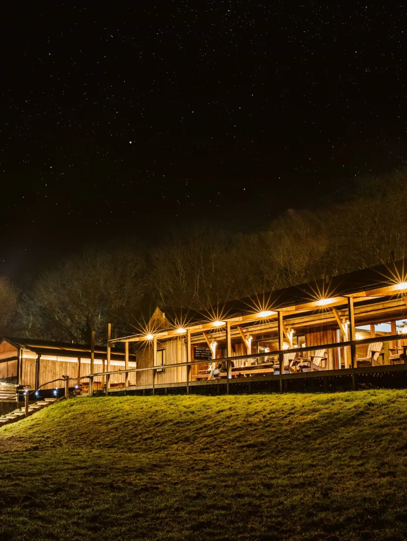 Outside the buildings of Fforest accommodation at night.