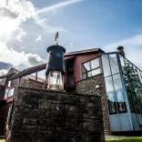 A mining lamp on a wall outside a mining visitor centre.