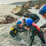 Group of people coasteering near St Davids on the south coast